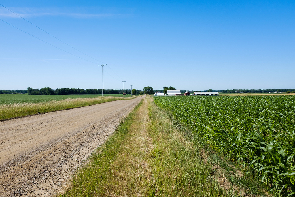 flat-gravel-road-and-farm